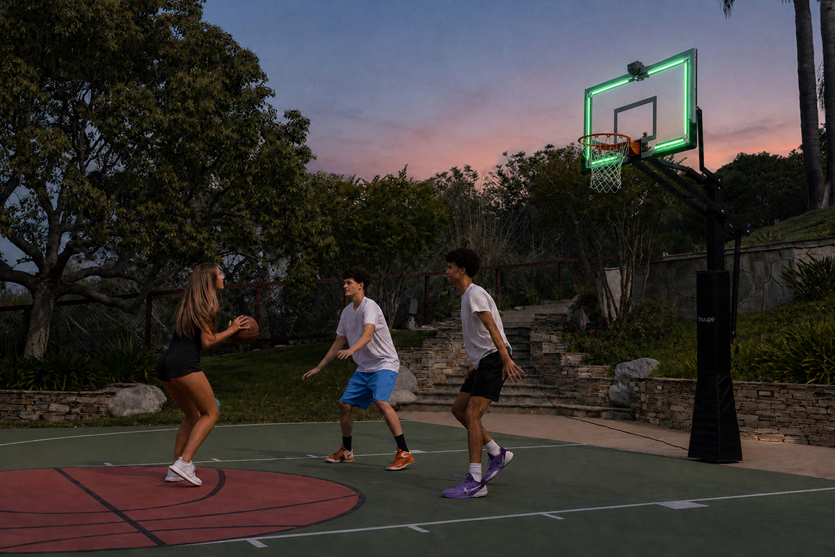 Kids playing under the glowing huupe ARENA at dusk